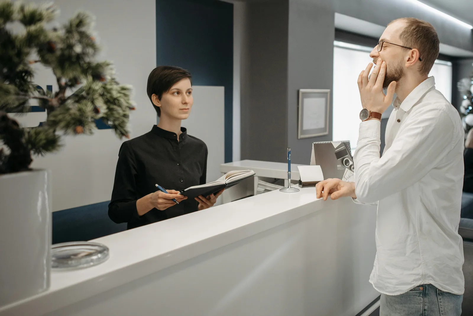 Dental front desk team using AI-assisted patient communication tools to reduce no-shows and improve scheduling